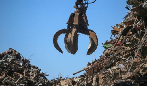 istockphoto-1177150469-612×612 Close-up industrial claw machine, move scrap metal in the landfill. Excavator arm, claw crane.